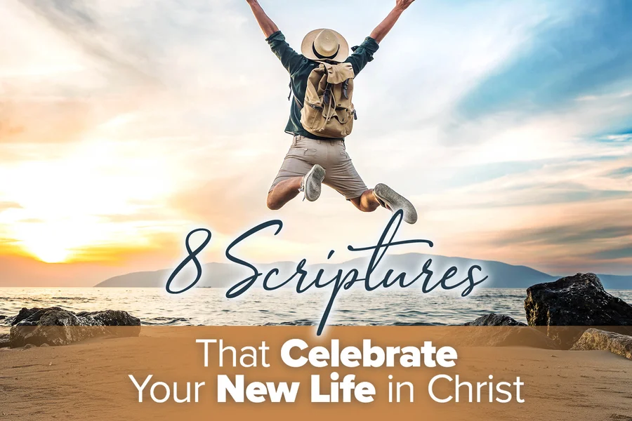 Man jumping at the beach, wearing a backpack