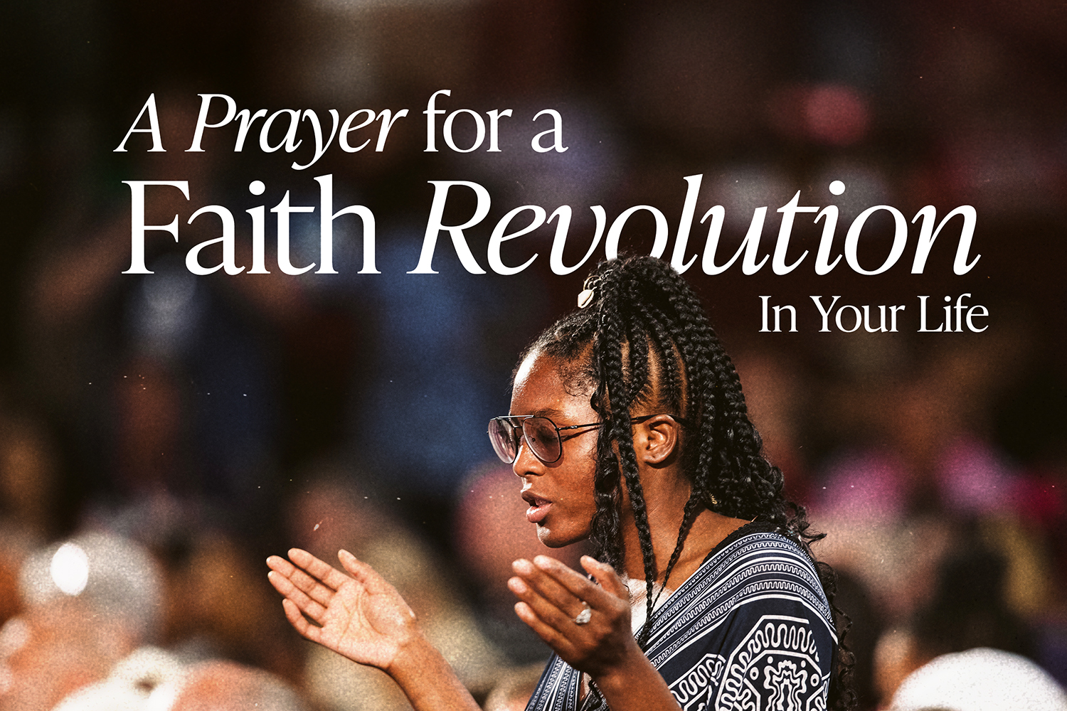 Woman praying and raising her hands at Southwest Believers Convention