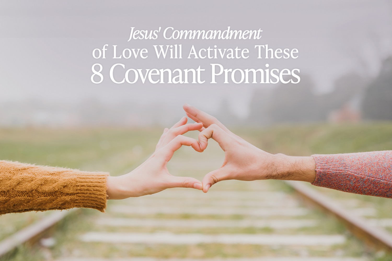 Two hands making a heart on a background of train tracks and a gray sky