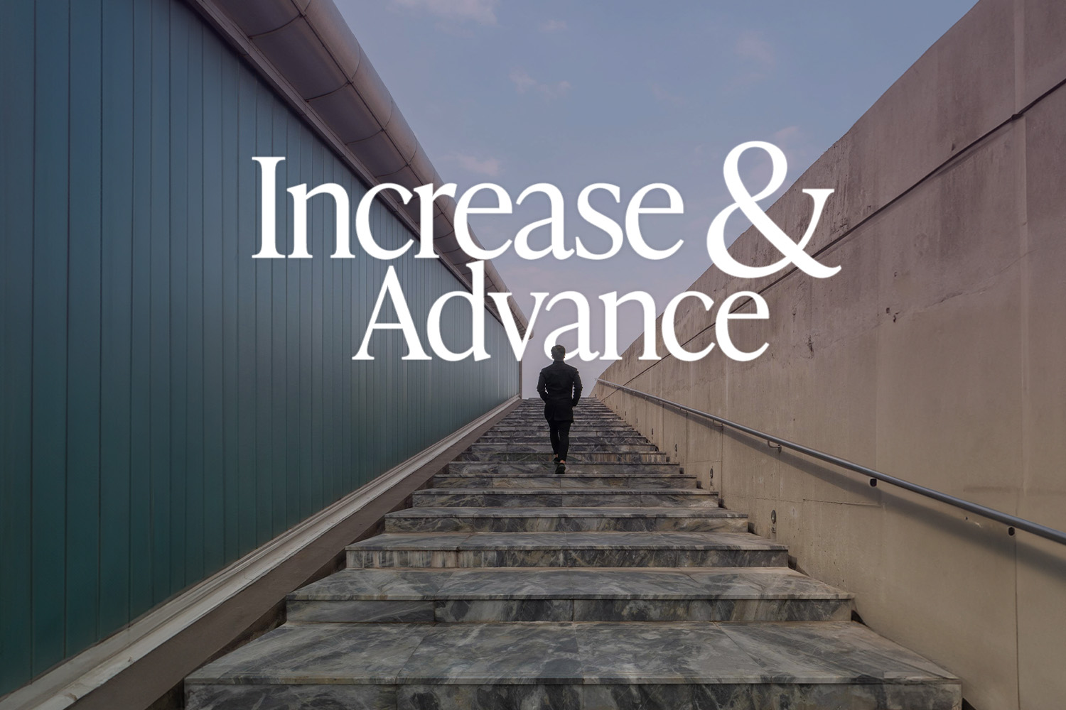 A man walking upstairs in the distance between two walls, heading toward an unknown destination.