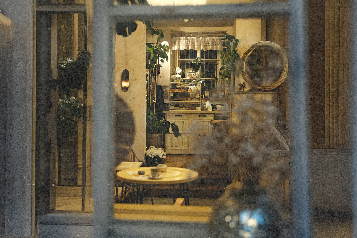 Looking through a window into a kitchen