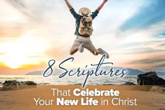 Man jumping at the beach, wearing a backpack