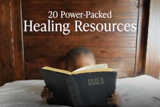 Young boy reading his bible in bed on a wooden background