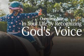 Little girl in a blue coat and helmet riding a brown horse