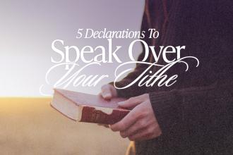 A woman standing in a field holding a Bible